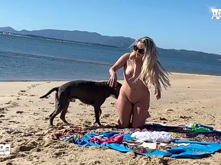 Woman having sex with dog on beach
